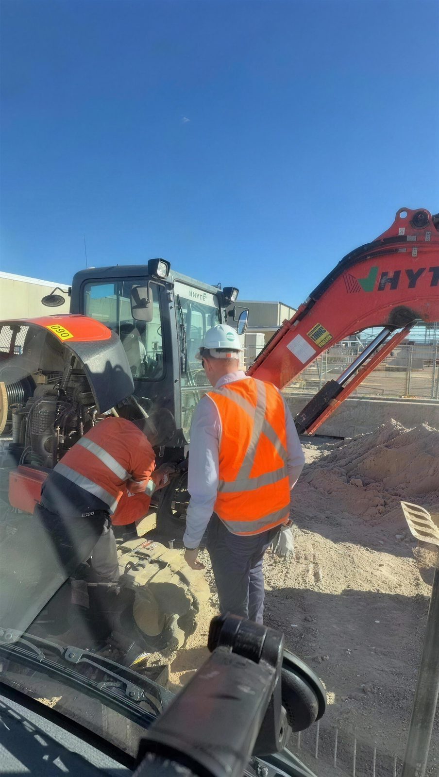 On-site breakdown repair next to an excavator