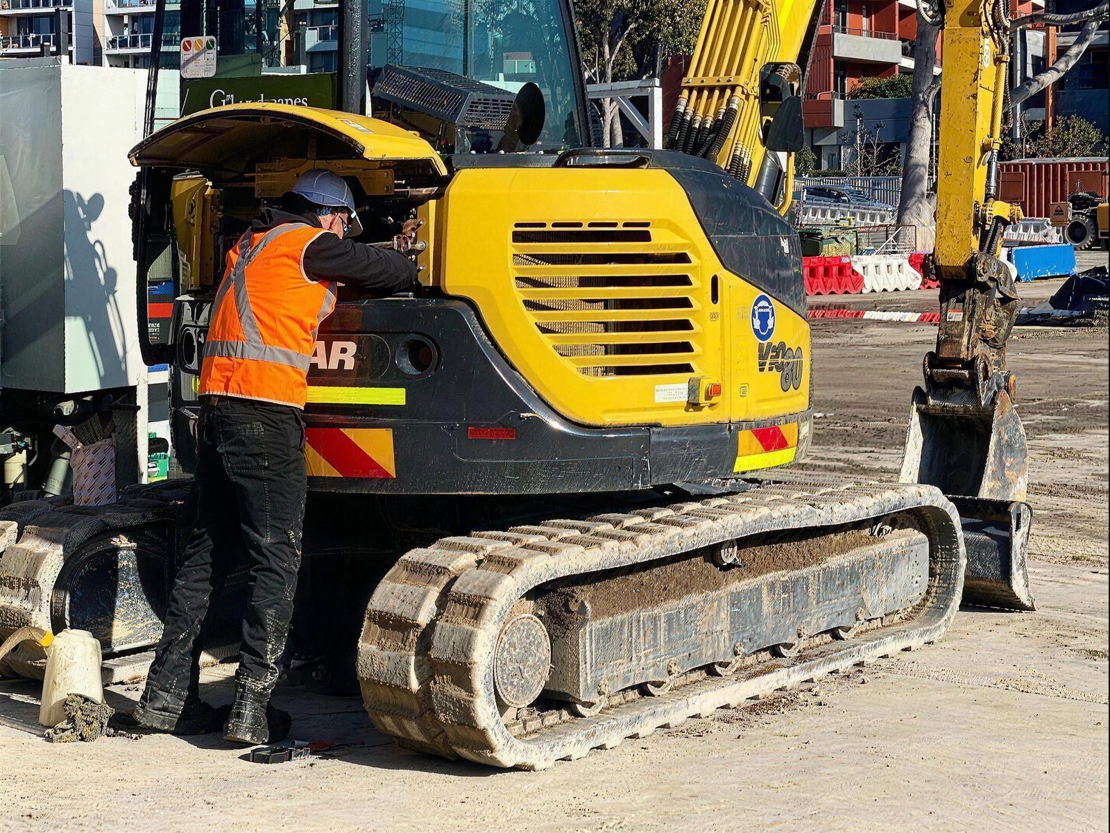 EMTR mechanic servicing a Yanmar excavator engine on site in Sydney